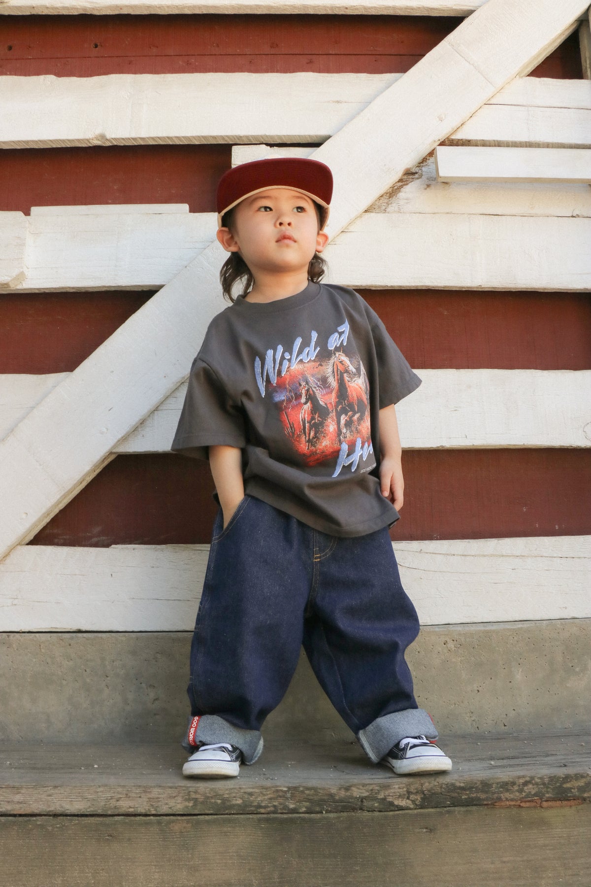 Child wearing black Wild at Heart horses T-shirt