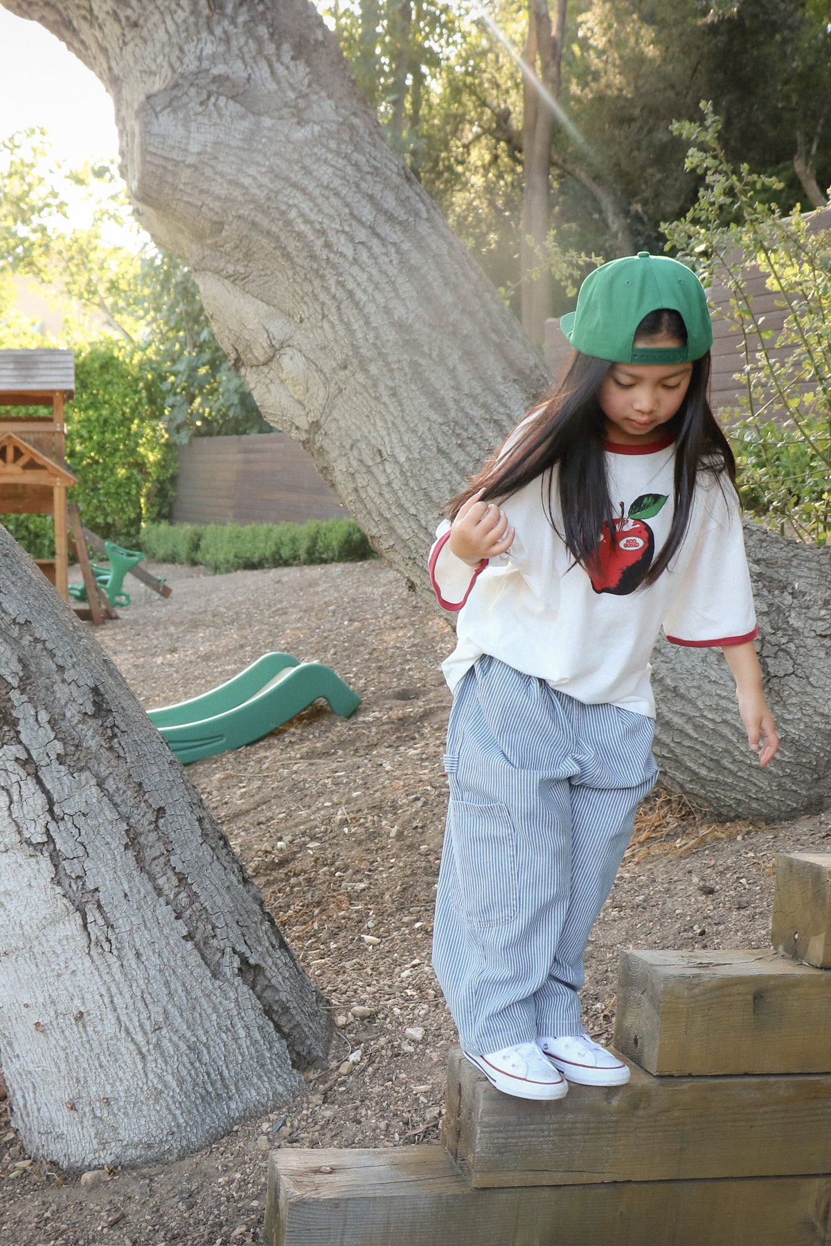 Child wearing baggy hickory stripe jeans