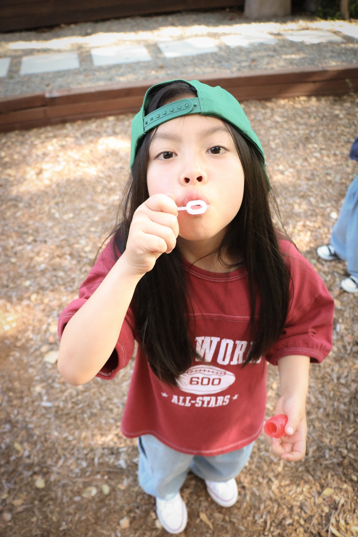 Child wearing burgundy Goo World All-Stars T-shirt