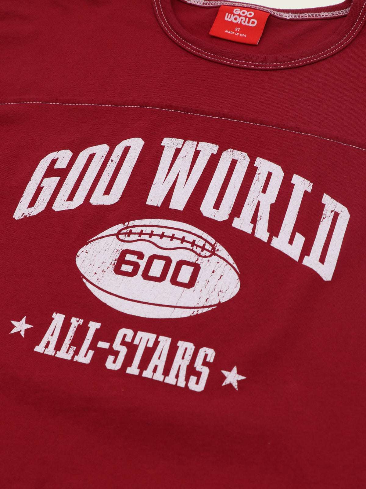 Goo World All-Stars football graphic on burgundy cotton ringer T-shirt with contrast stitching and yoke detail