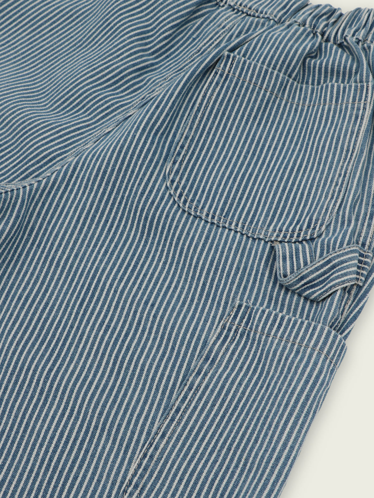 Patch pocket and faux tacked-on hammer loop detail on hickory stripe jeans with elastic waist
