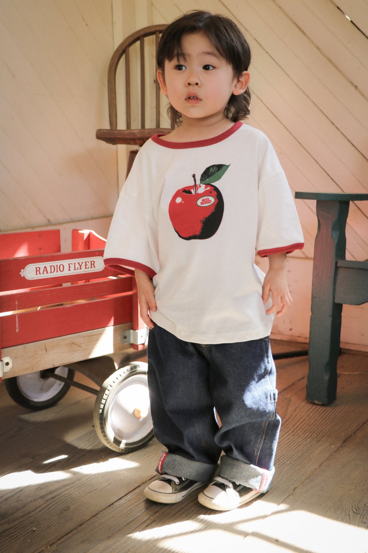 Child wearing baggy dark denim GOO WORLD jeans