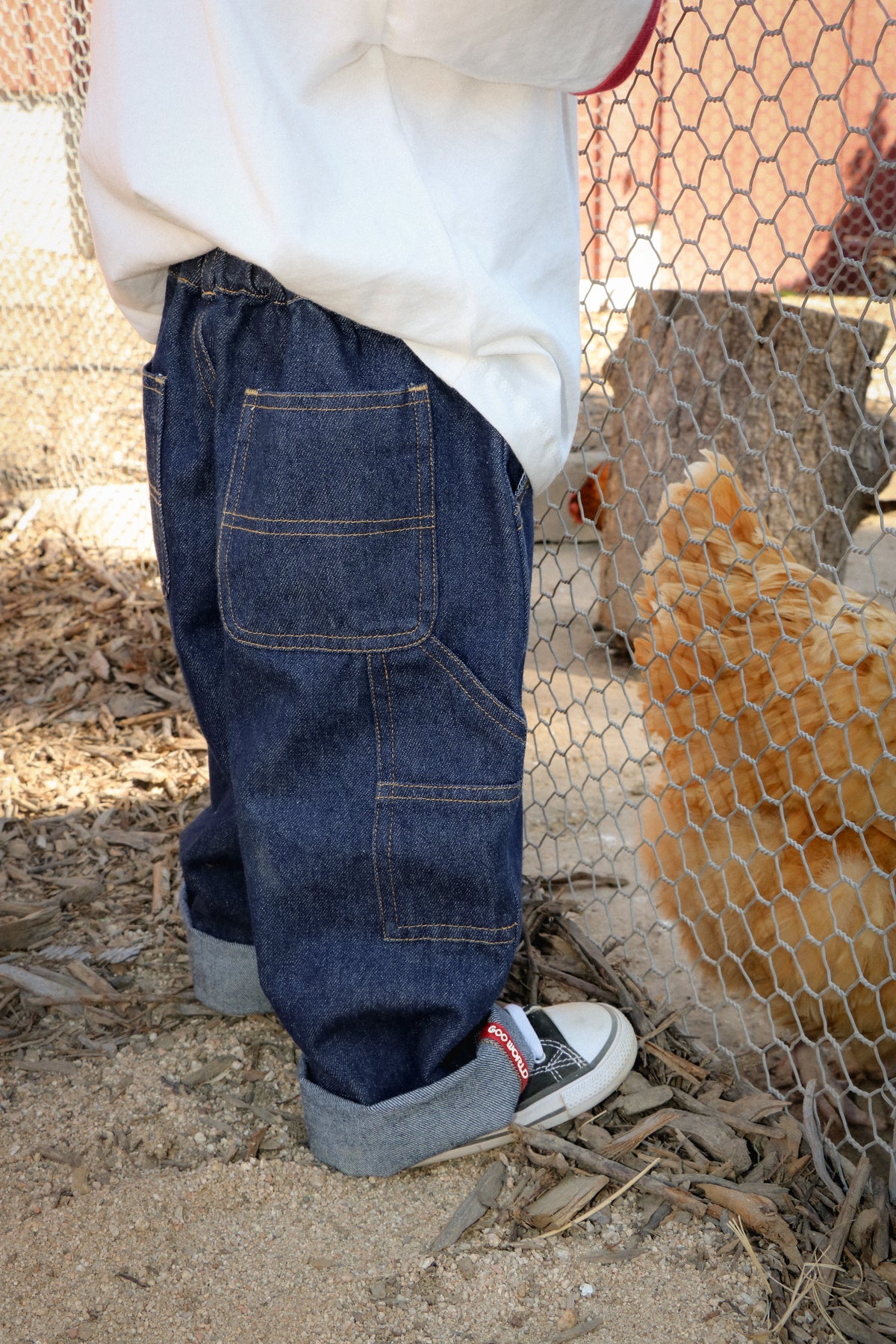 Child wearing GOO WORLD Workshop Jeans outdoors